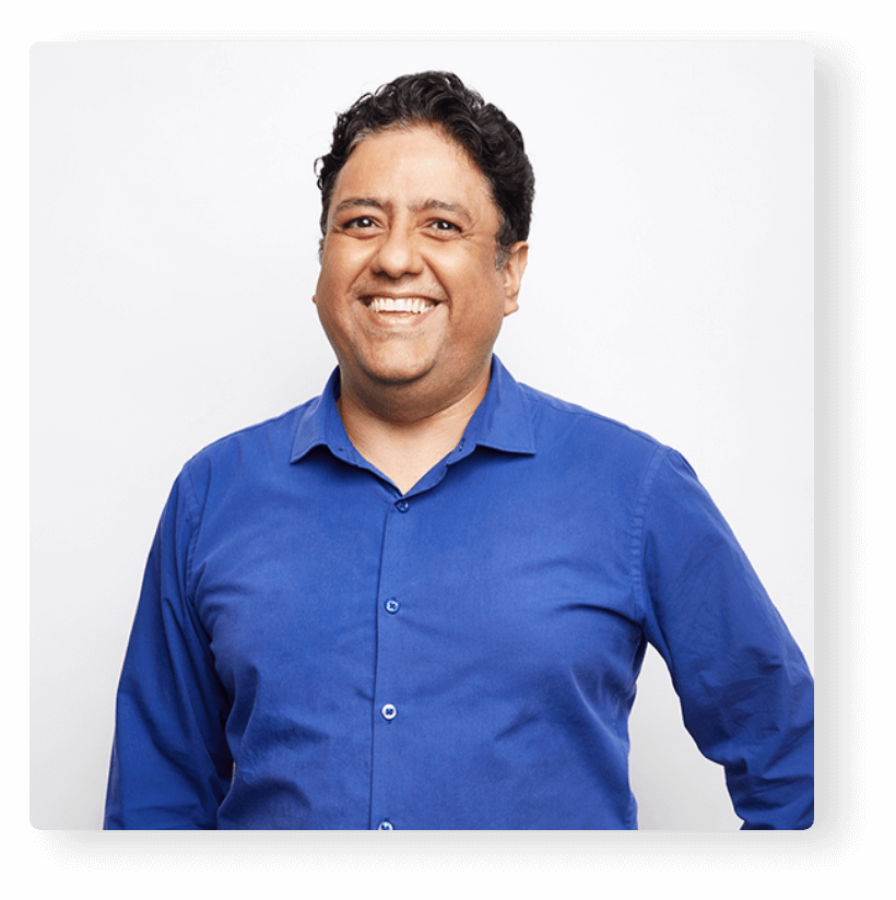 Man with a blue shirt smiling to camera