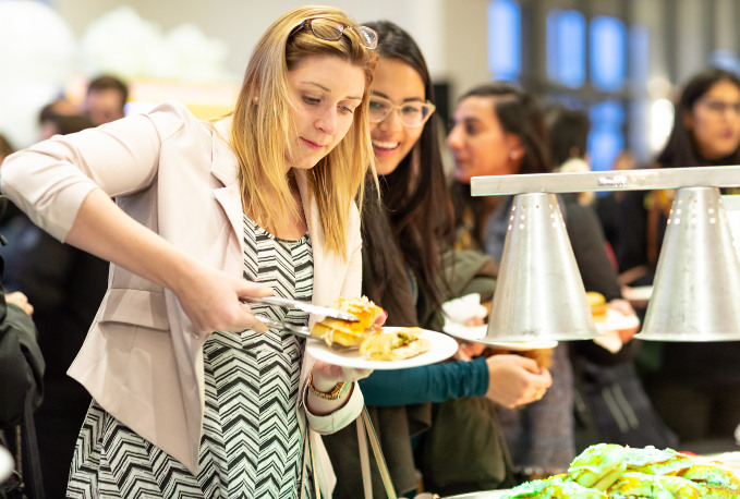 Women taking food on a company event